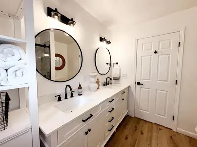 a white bathroom with a sink and a mirror at Fabulous Glamping Spot in Truckee, California: Charming Cabin near Lake Donner in Truckee