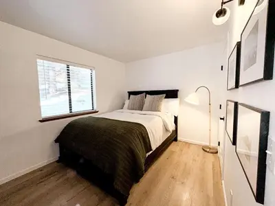 a white bedroom with a bed and a window at Fabulous Glamping Spot in Truckee, California: Charming Cabin near Lake Donner in Truckee