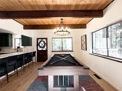 a room with a pool table in the middle of it at Fabulous Glamping Spot in Truckee, California: Charming Cabin near Lake Donner in Truckee