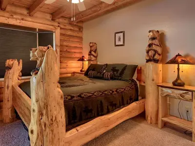 a bedroom with a bed in a log cabin at Exceptionally Spacious Log Cabin for Groups in Mariposa, California in Mariposa