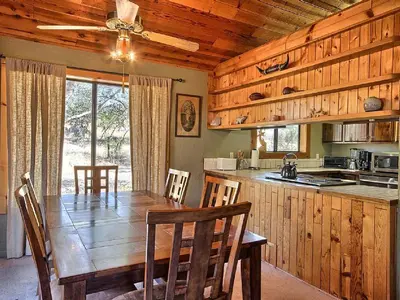 a kitchen and dining room with a wooden table and chairs at Family-Friendly Cabin near Yosemite National Park in California in Mariposa