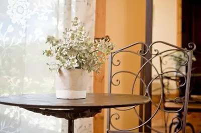 a vase of flowers sitting on a table at Exquisite Cottage Rental on Peaceful Vineyard near Bear Valley, California in Angels Camp