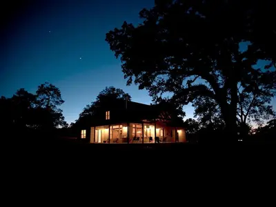 a house lit up at night with lights at Exquisite Cottage Rental on Peaceful Vineyard near Bear Valley, California in Angels Camp