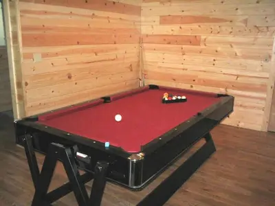 a red pool table in a room with a wall at Exceptional Riverside Cabin Rental in the Trees near Pinecrest Lake, California in Strawberry