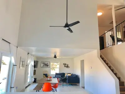 a living room with a ceiling fan and a table at Magical property in the Alabama Hills - HOT TUB in Lone Pine