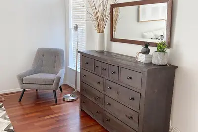 a dresser with a mirror and a chair in a room at 3 B 2 BA home in a Serene, quiet cul de sac in Lone Pine