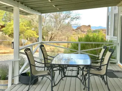 a table and chairs on a porch with a view at 3 B 2 BA home in a Serene, quiet cul de sac in Lone Pine