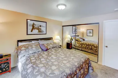 a bedroom with a large bed and a large mirror at San Sierra #16 Hot Tub Sauna Near Skiing in Mammoth Lakes