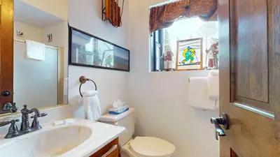 a bathroom with a sink and a toilet and a mirror at Serene Sierra Sanctuary Experience Mammoth Magic in Mammoth Lakes