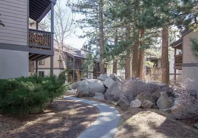 a garden with rocks and a walkway next to a house at Sherwin Villas Free Shuttle & Near Skiing in Mammoth Lakes
