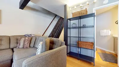a living room with a couch and a staircase at Sherwin Villas Retreat DT in Mammoth Lakes