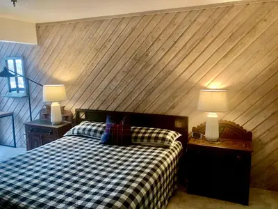 a bedroom with a checkered bed with two night stands and lamps at Aspen Creek #114 Near Year-Round Activities in Mammoth Lakes