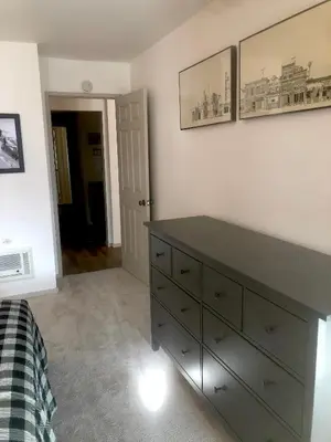 a bedroom with a dresser and pictures on the wall at Aspen Creek #114 Near Year-Round Activities in Mammoth Lakes