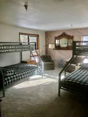 a room with two bunk beds and a couch at Aspen Creek #114 Near Year-Round Activities in Mammoth Lakes
