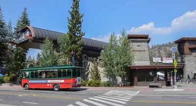 a red and green bus driving under a bridge at Aspen Creek #119 Shared Pool Hot Tub & BBQ in Mammoth Lakes