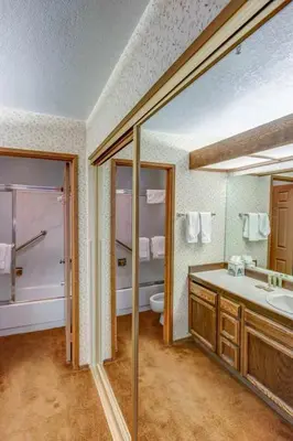 a bathroom with a tub and a toilet and a sink at Aspen Creek #119 Shared Pool Hot Tub & BBQ in Mammoth Lakes