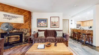 a living room with a couch and a fireplace at Aspen Creek #215 Hot Tubs Near Golf & Hiking in Mammoth Lakes