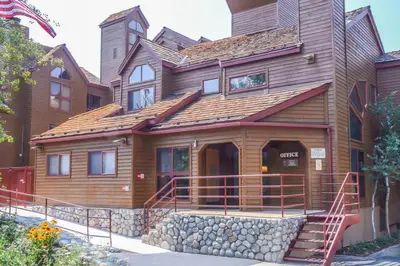 a large wooden house with a staircase in front of it at Aspen Creek #215 Hot Tubs Near Golf & Hiking in Mammoth Lakes