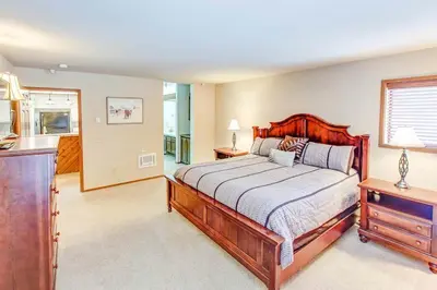 a bedroom with a large bed with a wooden frame at Aspen Creek #225 Hot Tub & Pool Near Skiing in Mammoth Lakes