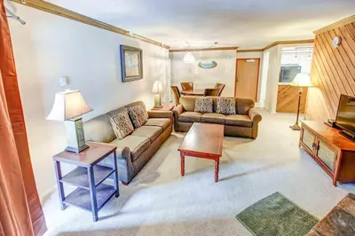 a living room with a couch and a table at Aspen Creek #225 Hot Tub & Pool Near Skiing in Mammoth Lakes