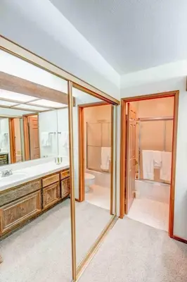 a bathroom with a tub and a sink and a mirror at Aspen Creek #225 Hot Tub & Pool Near Skiing in Mammoth Lakes