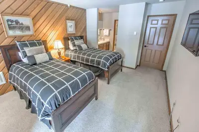 a hotel room with two beds and a door at Aspen Creek #225 Hot Tub & Pool Near Skiing in Mammoth Lakes