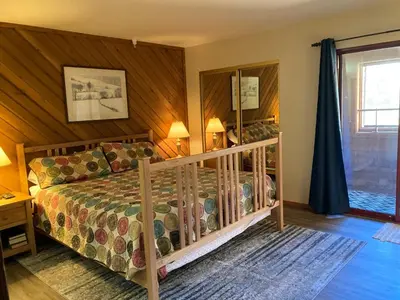 a bedroom with a bed and a mirror at Aspen Creek #226 Year-Round Activities in Mammoth Lakes