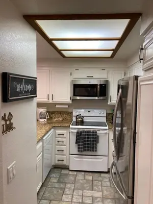 a white kitchen with a stove and a refrigerator at Aspen Creek #226 Year-Round Activities in Mammoth Lakes
