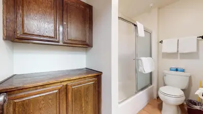 a bathroom with a toilet and a glass shower at Aspen Creek Shared Amenities Near Hiking in Mammoth Lakes