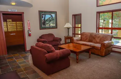 a living room with a couch and a table at Aspen Creek Shared Amenities Near Hiking in Mammoth Lakes