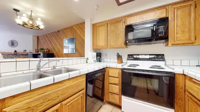 a kitchen with a sink and a microwave at Aspen Creek Shared Amenities Near Hiking in Mammoth Lakes