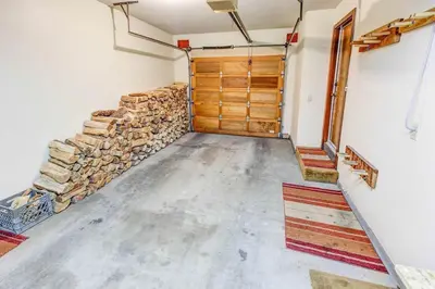 a garage with a stack of logs and a wooden door at Canyon Ski & Racquet #1 Near Hike & Bike Trails in Mammoth Lakes