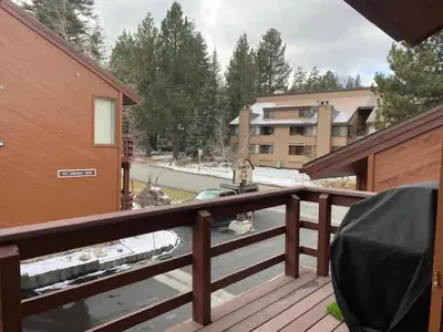 a balcony with a wooden railing and a building at Canyon Ski & Racquet #1 Near Hike & Bike Trails in Mammoth Lakes