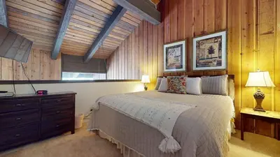 a bedroom with a bed and a dresser and a window at Canyon Ski Gateway Condo for 4 in Mammoth Lakes