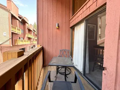 a chair sitting on the balcony of a building at Canyon Ski Gateway Condo for 4 in Mammoth Lakes
