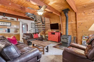 a living room with leather furniture and a fireplace at Fire Escape Cabin-Southern Yosemite in Oakhurst