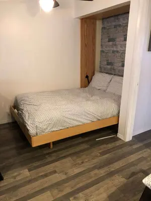 a small bed in a room with a wooden floor at Sierra Manors In the Heart of Mammoth in Mammoth Lakes