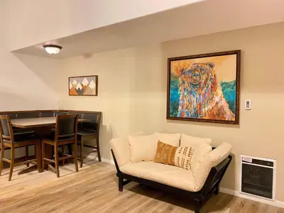 a living room with a couch and a painting of a dog at Sierra Manors #098 Nearby Hike & Bike Trails in Mammoth Lakes