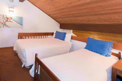 a bedroom with two beds with blue pillows at Snowcreek #059 Near Shuttle & Activities in Mammoth Lakes