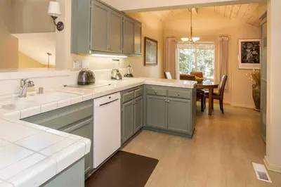 a kitchen with blue cabinets and a dining room at Snowcreek #566 Near Golf & Shuttle in Mammoth Lakes