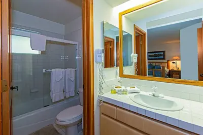 a bathroom with a sink and a toilet and a mirror at SnowCreek #936 Shared Pool & Hot Tub in Mammoth Lakes