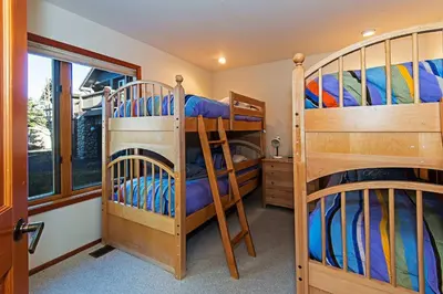 a room with two bunk beds and a window at SnowCreek #936 Shared Pool & Hot Tub in Mammoth Lakes