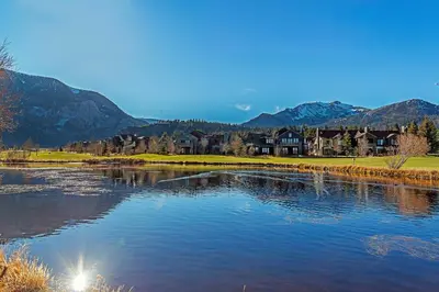 a body of water with houses and mountains in the background at SnowCreek #936 Shared Pool & Hot Tub in Mammoth Lakes