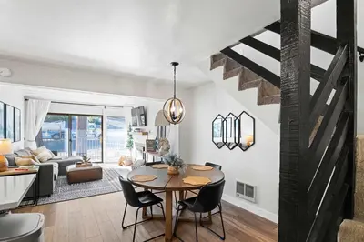 a dining room and living room with a table and a living room at St Anton Getaway Shared BBQ Pool & Hot Tub in Mammoth Lakes
