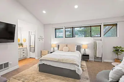 a white bedroom with a bed and a tv at St Anton Getaway Shared BBQ Pool & Hot Tub in Mammoth Lakes