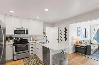 a kitchen with white cabinets and a white counter top at St Anton Getaway Shared BBQ Pool & Hot Tub in Mammoth Lakes