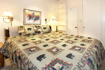a bedroom with a bed with a quilt on it at Chamonix Year-Round Fun with Shared Pool in Mammoth Lakes