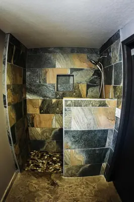 a bathroom with a stone wall with a shower at Chamonix Year-Round Fun with Shared Pool in Mammoth Lakes