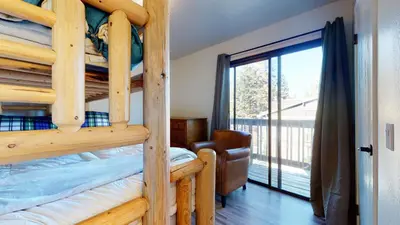 a bedroom with two bunk beds and a balcony at Crestview #2 Close to The Village Near Year-Round Outdoor Activities in Mammoth Lakes