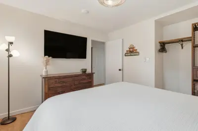 a bedroom with a bed and a flat screen tv at Bearfoot Cabin 15 Min to Yosemite Gate! in Oakhurst